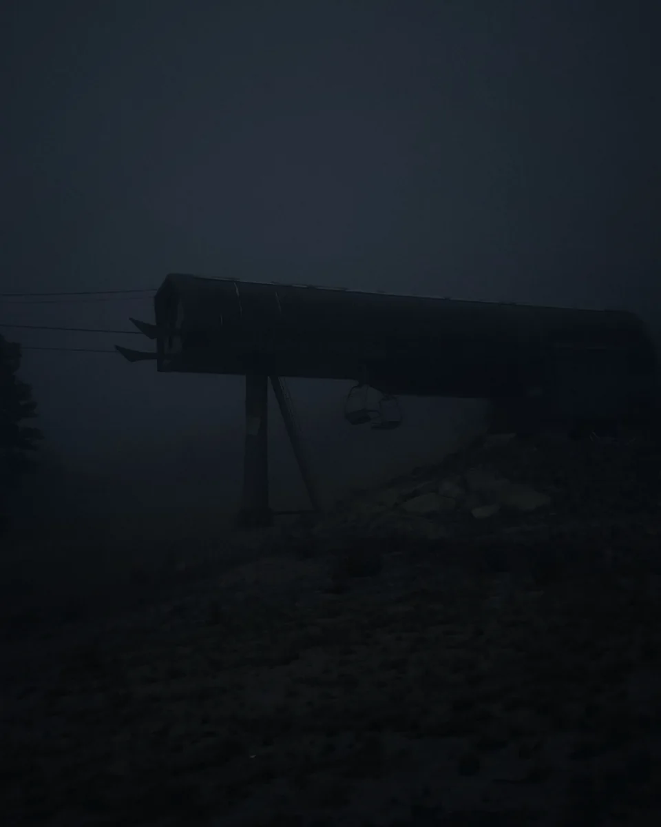 A ski lift station in thick blue fog